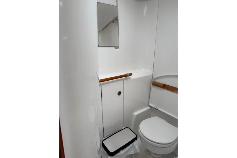 Slide: The Image of Bathroom interior of 2006 Beneteau Oceanis Clipper 393 yacht, featuring toilet and mirror. - 27