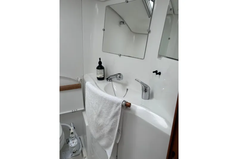 Slide: The Image of Bathroom interior of 2006 Beneteau Oceanis Clipper 393 yacht, featuring sink and mirror. - 28