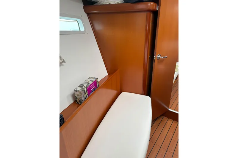 Slide: The Image of Interior of 2006 Beneteau Oceanis Clipper 393, featuring wooden cabinetry and cushioned seating. - 30