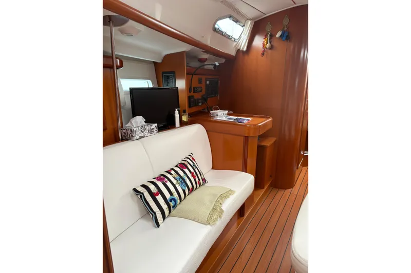 Slide: The Image of Interior of 2006 Beneteau Oceanis Clipper 393 yacht with cozy seating and nautical decor. - 31