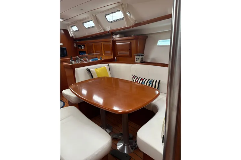 Slide: The Image of Interior of 2006 Beneteau Oceanis Clipper 393 yacht with wooden table and white seating. - 32