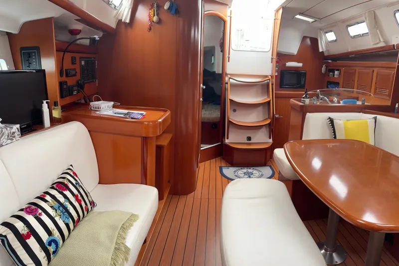 Slide: The Image of Interior of 2006 Beneteau Oceanis Clipper 393 yacht with cozy seating and wooden finishes. - 33
