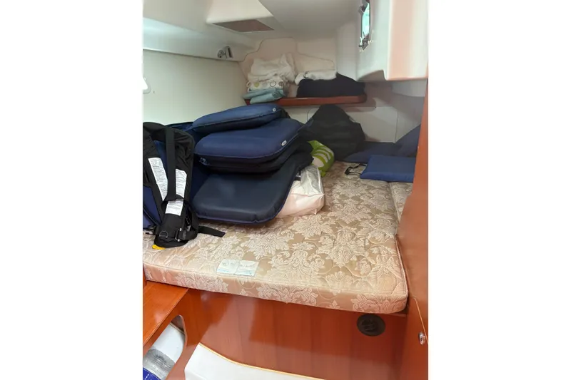 Slide: The Image of 2006 Beneteau Oceanis Clipper 393 cabin with storage and cushions. - 34