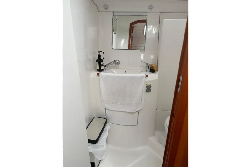 Slide: The Image of Compact bathroom in a 2006 Beneteau Oceanis Clipper 393 yacht, featuring a sink and mirror. - 37