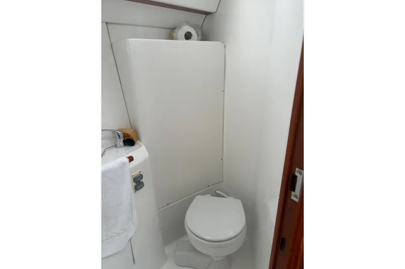Slide: The Image of Bathroom of 2006 Beneteau Oceanis Clipper 393 yacht, featuring compact toilet and sink. - 38