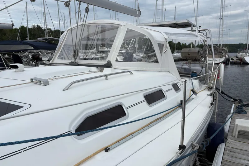 Slide: The Image of 2006 Beneteau Oceanis Clipper 393 sailboat docked at marina, featuring sleek design and white canopy. - 8