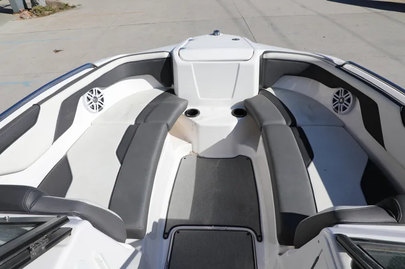 Slide: The Image of 2022 Yamaha Boats AR210 interior with gray seating and cup holders. - 14