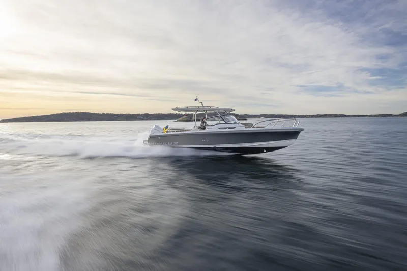 The Image of Nimbus Tender 9 boat 2025 cruising on calm waters at sunset. - 1