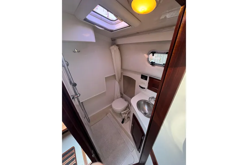 Slide: The Image of Compact bathroom in 2006 Shannon Shoalsailer yacht with skylight and modern fixtures. - 18