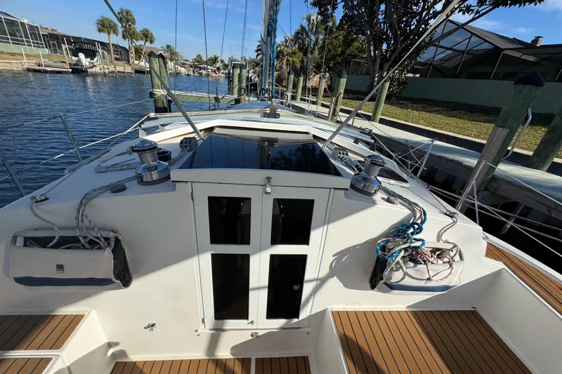 Slide: The Image of 2006 Shannon Shoalsailer sailboat docked, showcasing deck and rigging details. - 6