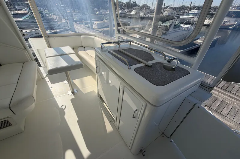 Slide: The Image of 2011 Cruisers Yachts 415 Express Motoryacht interior with seating and kitchenette. - 10