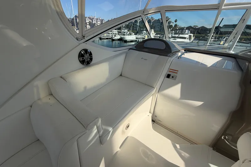 Slide: The Image of 2011 Cruisers Yachts 415 Express Motoryacht interior with white seating and marina view. - 11