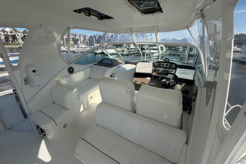 Slide: The Image of 2011 Cruisers Yachts 415 Express Motoryacht interior with white seating and modern helm. - 13
