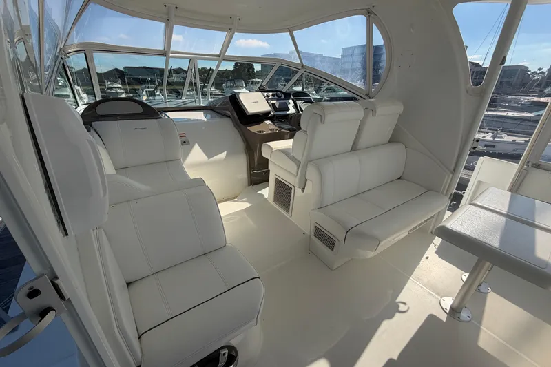 Slide: The Image of 2011 Cruisers Yachts 415 Express Motoryacht interior with white seating and helm station. - 14