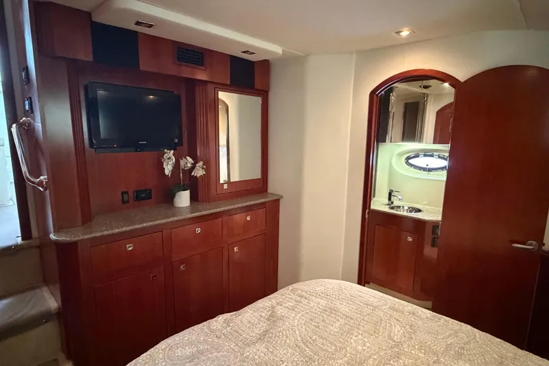 Slide: The Image of Luxurious 2011 Cruisers Yachts 415 Express Motoryacht interior with wood cabinetry and ensuite bathroom. - 20