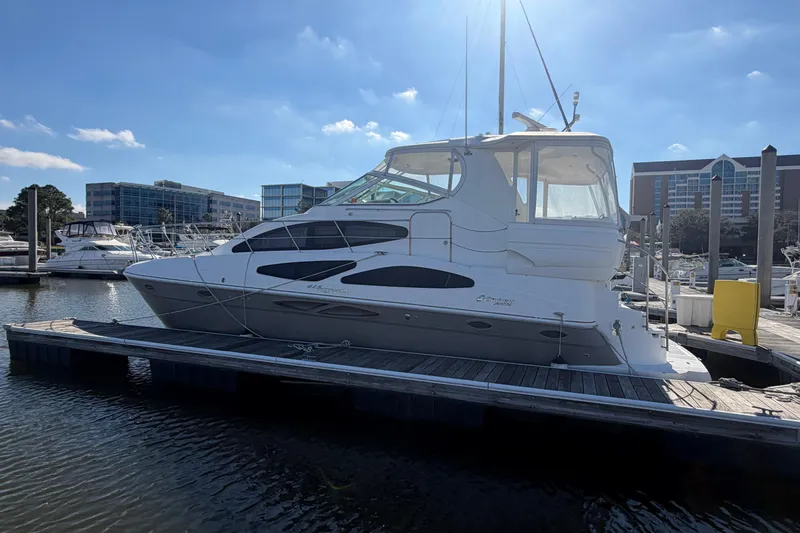 Slide: The Image of 2011 Cruisers Yachts 415 Express Motoryacht docked at marina under clear sky. - 3