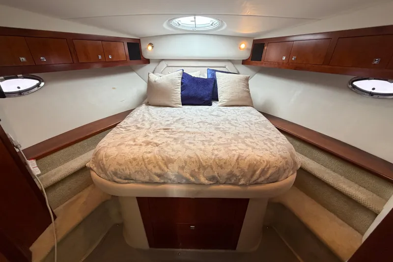Slide: The Image of Luxurious 2011 Cruisers Yachts 415 Express Motoryacht bedroom with elegant bedding and wood cabinetry. - 32