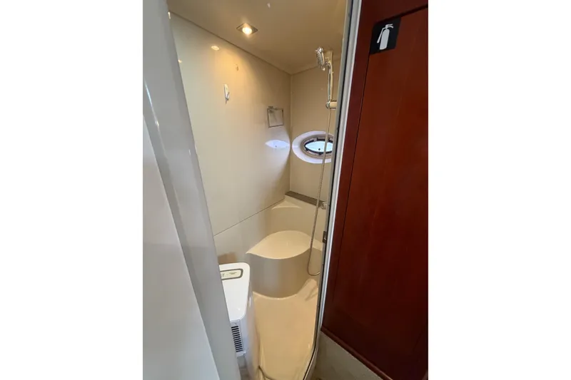Slide: The Image of 2011 Cruisers Yachts 415 Express Motoryacht bathroom with shower and porthole window. - 35