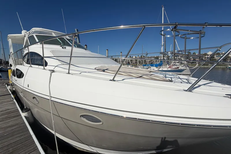 Slide: The Image of 2011 Cruisers Yachts 415 Express Motoryacht docked at marina under clear blue sky. - 5