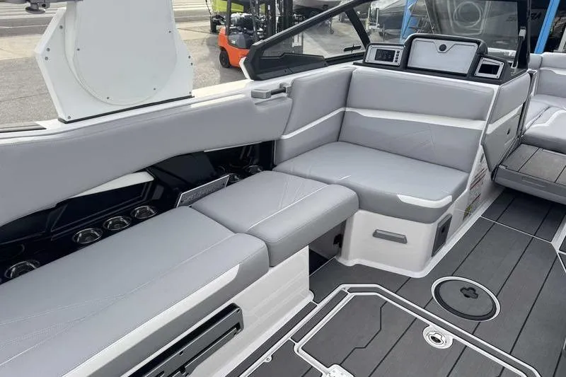 Slide: The Image of 2022 Supra SL boat interior with sleek gray seating and modern dashboard design. - 8