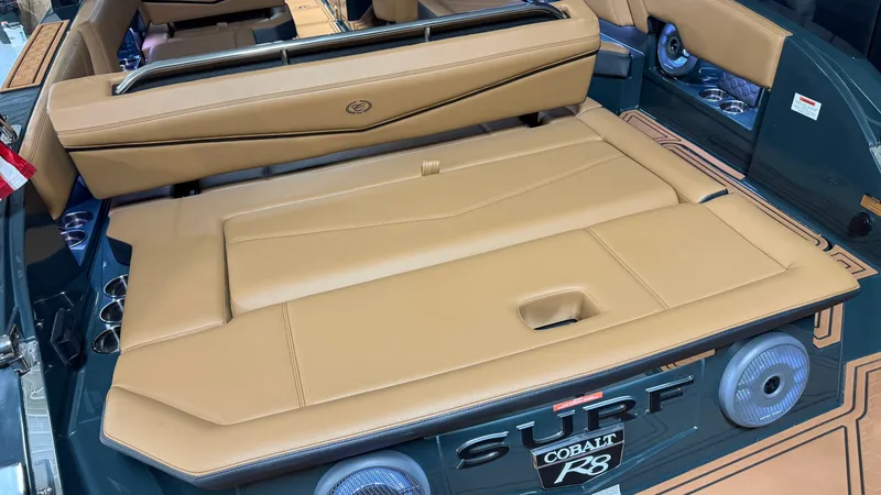 Slide: The Image of The image shows the rear of a Cobalt R8 Surf boat with beige upholstery. - 13