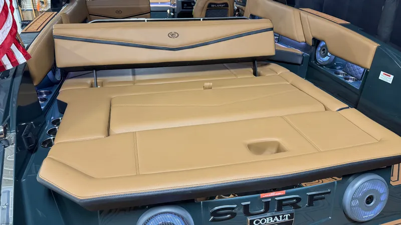 Slide: The Image of The image shows the spacious, cushioned aft deck of a Cobalt R8 Surf boat. - 17