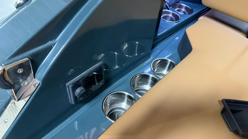 Slide: The Image of Close-up of cup holders and a control panel in a Cobalt R8 Surf boat. - 14