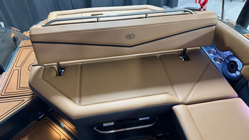 Slide: The Image of The image shows the luxurious brown leather seating area at the rear of a Cobalt R8 Surf boat. - 31