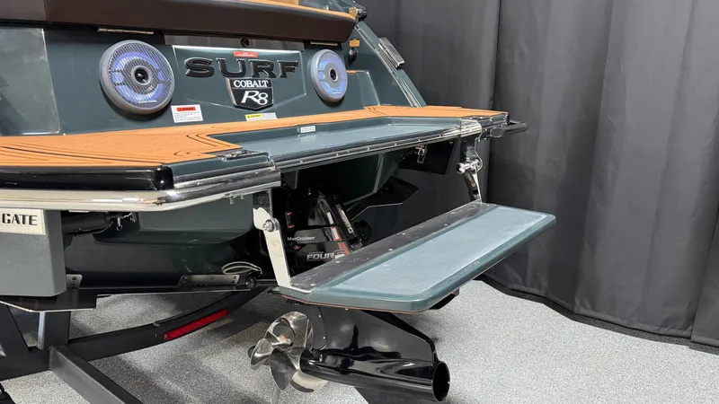 Slide: The Image of The image shows the rear of a Cobalt R8 Surf boat with a platform and propeller. - 10