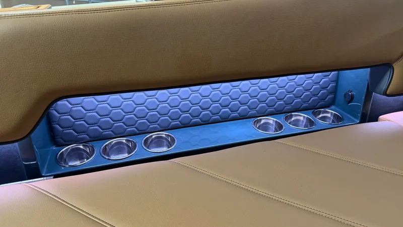Slide: The Image of Rear seat of a 2027 Cobalt R8 Surf with cup holders and blue lighting. - 37