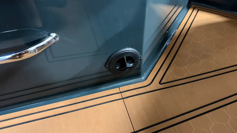 Slide: The Image of Close-up of a boat interior with wood-patterned flooring and a black vent. - 29