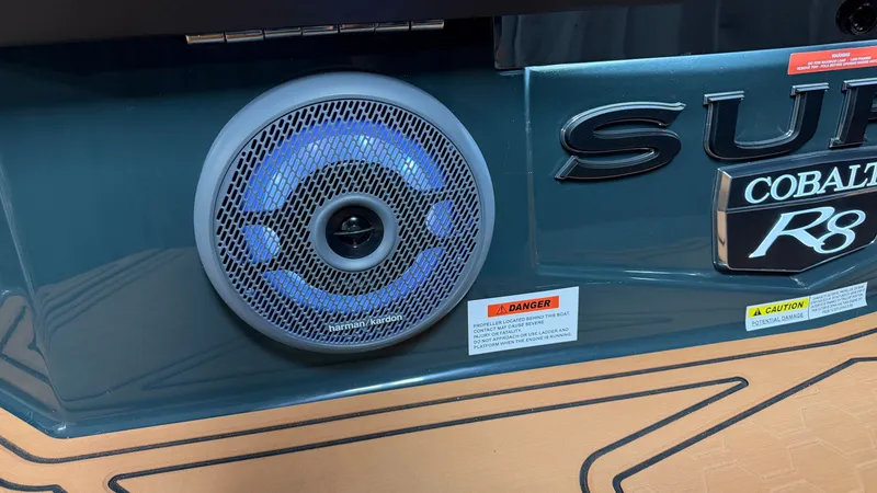 Slide: The Image of Close-up of a speaker on a 2027 Cobalt R8 Surf boat. - 12