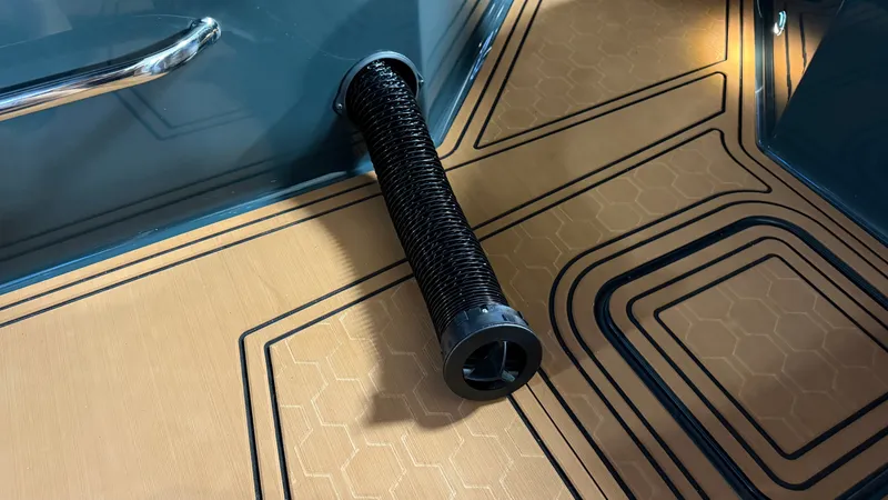 Slide: The Image of Close-up of a boat deck with a black, spiral handle. - 30