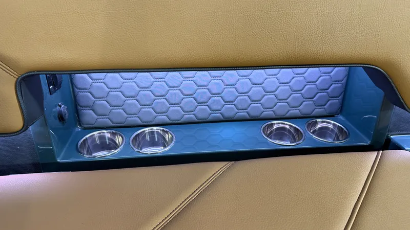 Slide: The Image of The interior of the 2027 Cobalt R8 Surf features a padded hexagonal-patterned back panel with built-in cup holders. - 26