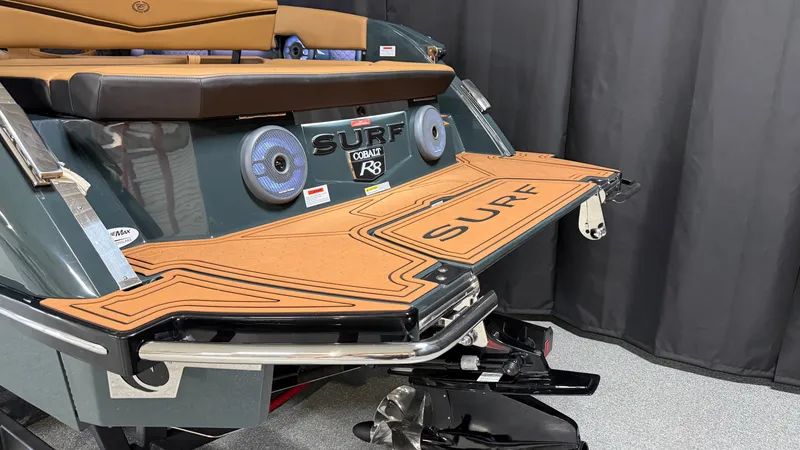 Slide: The Image of The image shows the stern of a Cobalt R8 Surf boat with a large swim platform. - 9