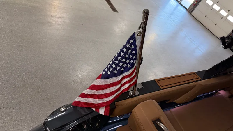 Slide: The Image of An American flag flies on a 2027 Cobalt R8 Surf boat. - 15