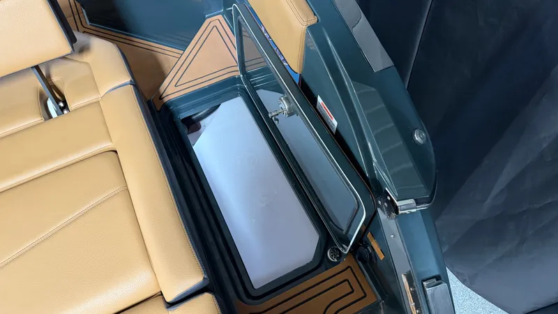 Slide: The Image of The image shows the interior of a 2027 Cobalt R8 Surf with brown seats and a storage compartment. - 22