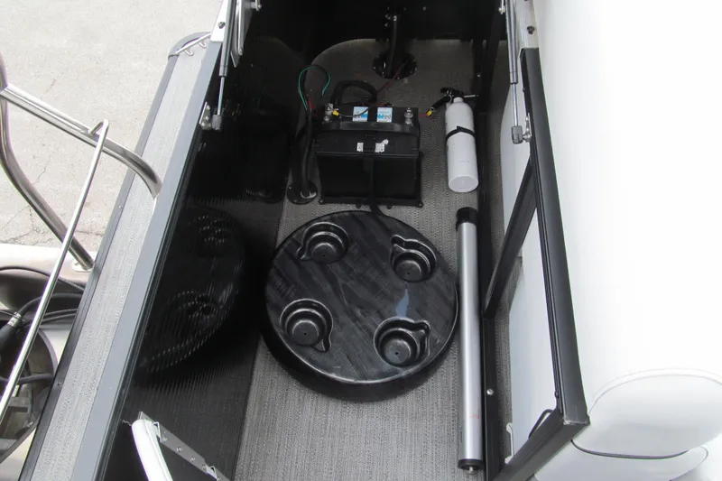 Slide: The Image of 2023 Godfrey Sweetwater 2286 C boat storage compartment with battery and accessories. - 14