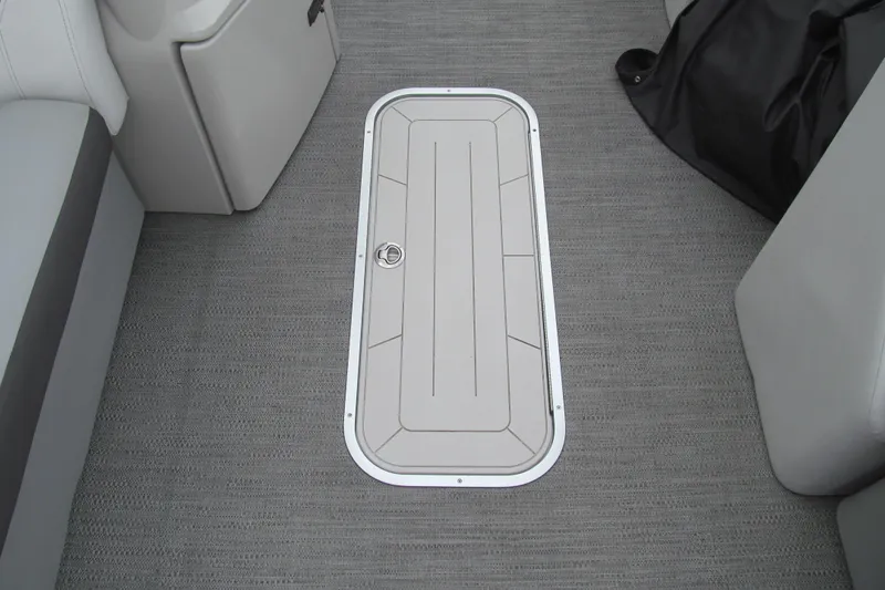 Slide: The Image of 2023 Godfrey Sweetwater 2286 C boat interior with storage hatch on carpeted floor. - 9