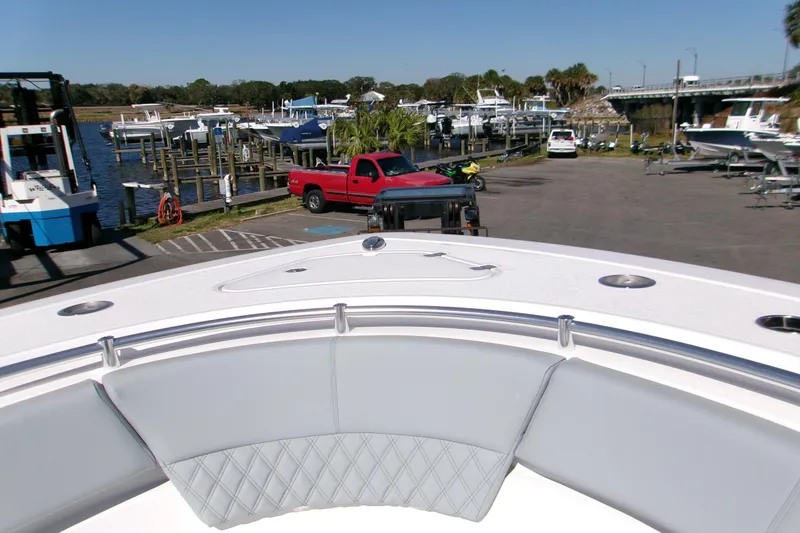 Slide: The Image of 2026 Sportsman Heritage 321 Center Console at marina with parked vehicles and boats. - 10