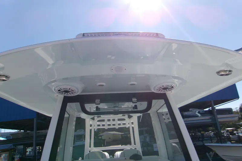 Slide: The Image of 2026 Sportsman Heritage 321 Center Console boat under bright sunlight. - 11