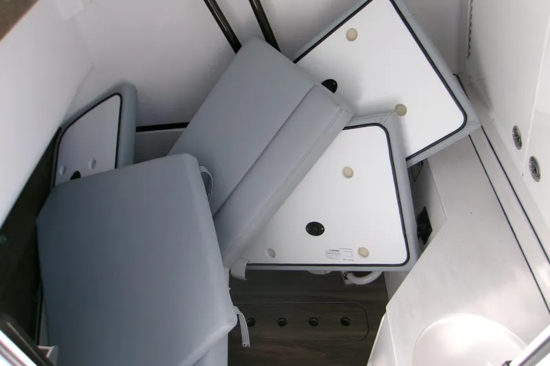 Slide: The Image of 2026 Sportsman Heritage 321 Center Console interior with folded cushions and storage area. - 13