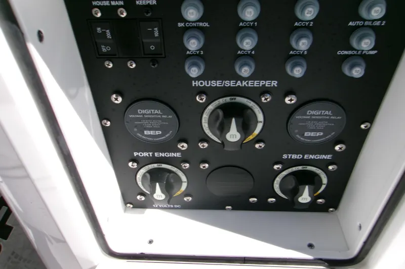 Slide: The Image of Control panel of 2026 Sportsman Heritage 321 Center Console boat, featuring engine and accessory switches. - 16