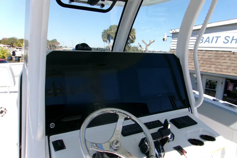 Slide: The Image of 2026 Sportsman Heritage 321 Center Console helm with steering wheel and control panel. - 3