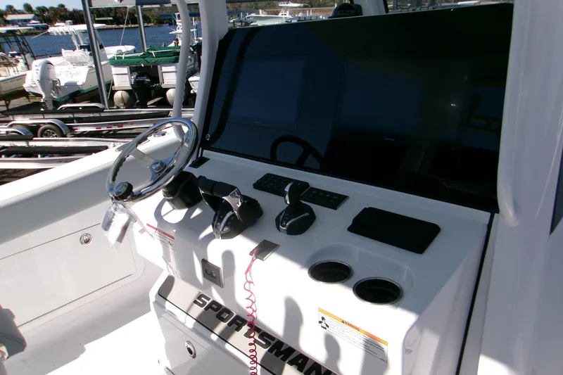 Slide: The Image of 2026 Sportsman Heritage 321 Center Console boat dashboard with steering wheel and controls. - 8