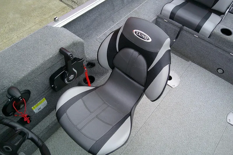 Slide: The Image of 2016 Lund 1775 Impact Sport boat interior with gray seating and control panel. - 11