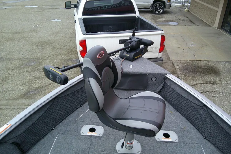 Slide: The Image of 2016 Lund 1775 Impact Sport boat with seating, parked near a white pickup truck. - 13
