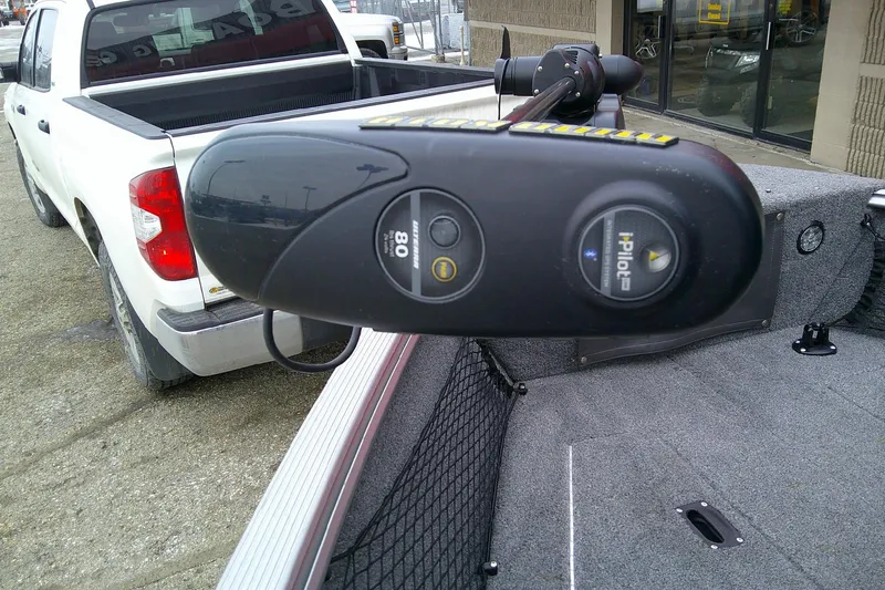 Slide: The Image of 2016 Lund 1775 Impact Sport boat with i-Pilot trolling motor, parked near a white pickup truck. - 14