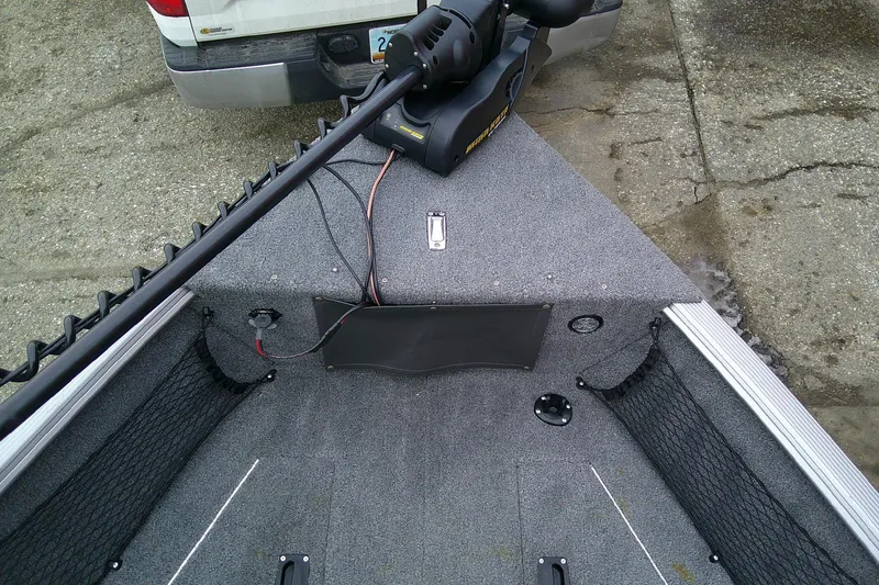 Slide: The Image of 2016 Lund 1775 Impact Sport boat interior with trolling motor and storage nets. - 15