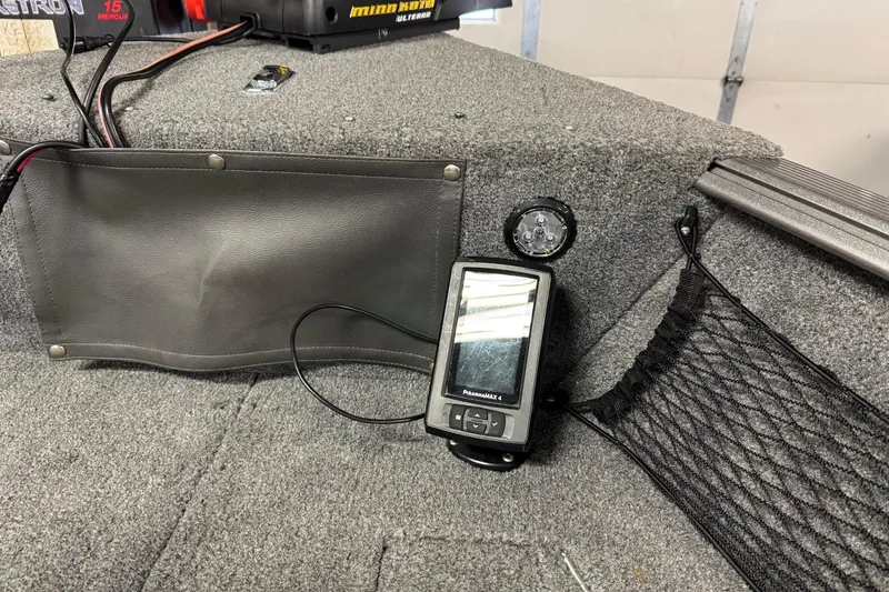 Slide: The Image of 2016 Lund 1775 Impact Sport boat interior with fish finder and storage compartments. - 16